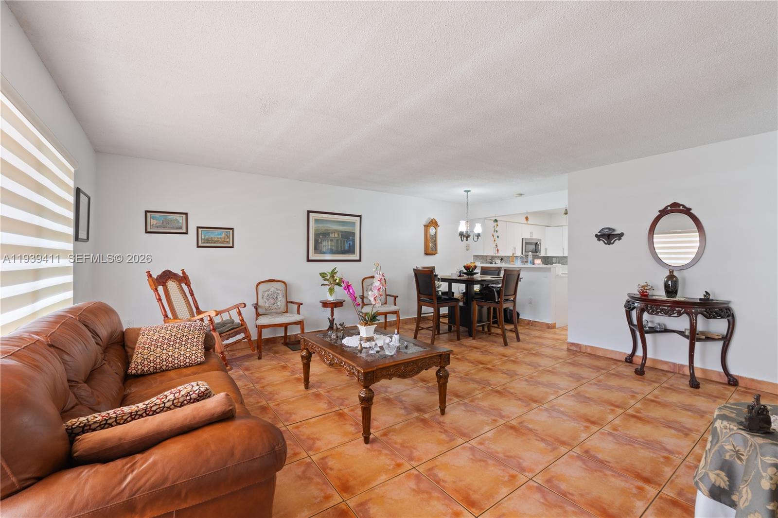 8480 Southwest 156th Place, Unit 620 Miami, FL 33193 - Photo 3 of 23 a living room with furniture a dining table and a window