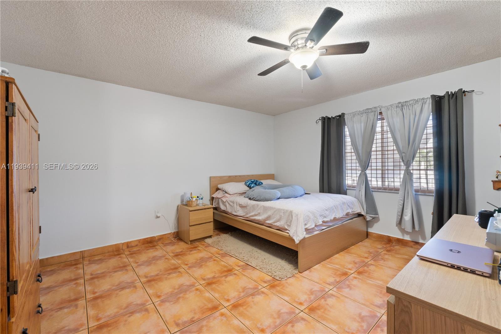 8480 Southwest 156th Place, Unit 620 Miami, FL 33193 - Photo 8 of 23 a bedroom with a bed and a large window