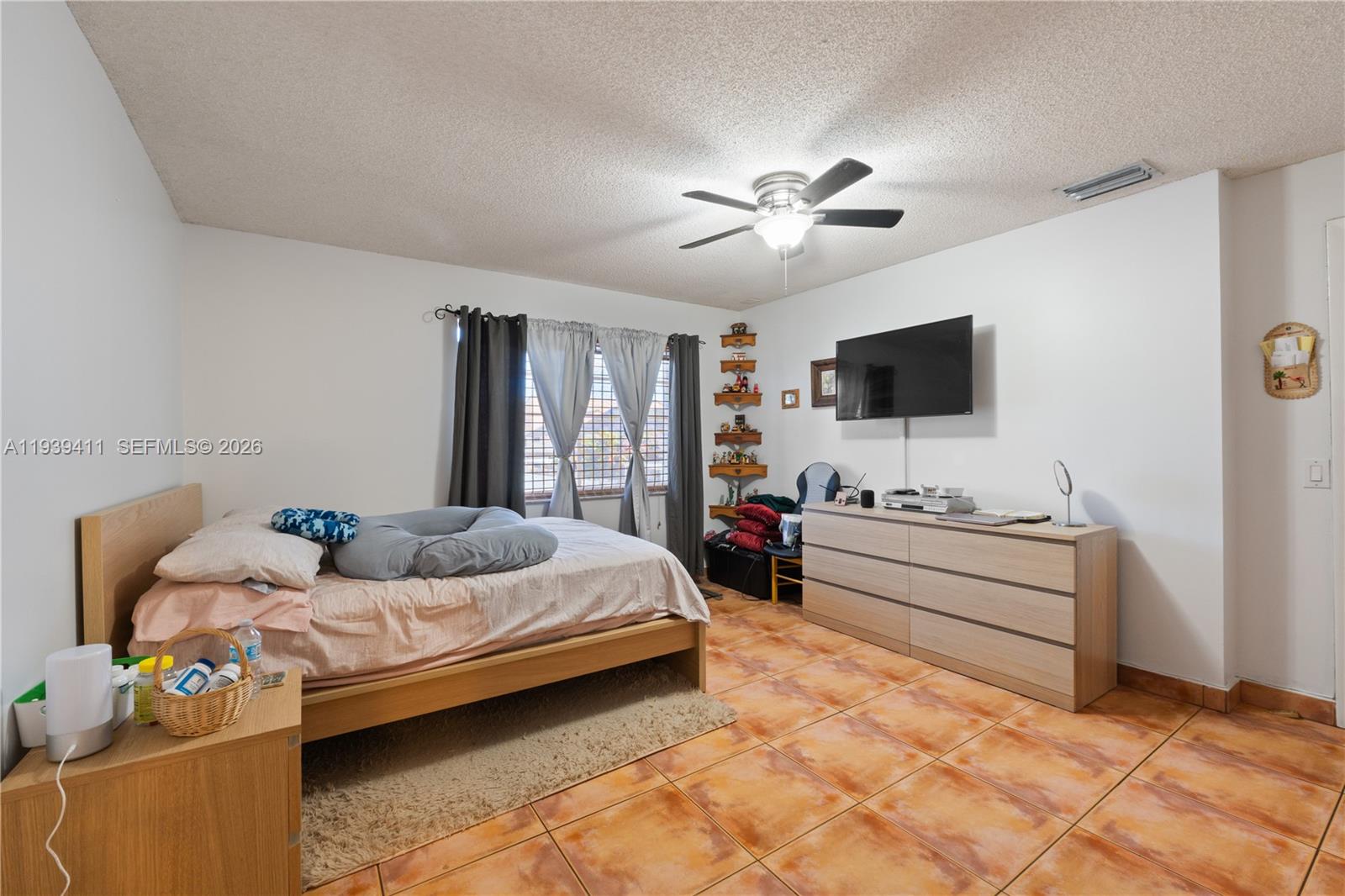 8480 Southwest 156th Place, Unit 620 Miami, FL 33193 - Photo 10 of 23 a bedroom with bed and flat screen tv