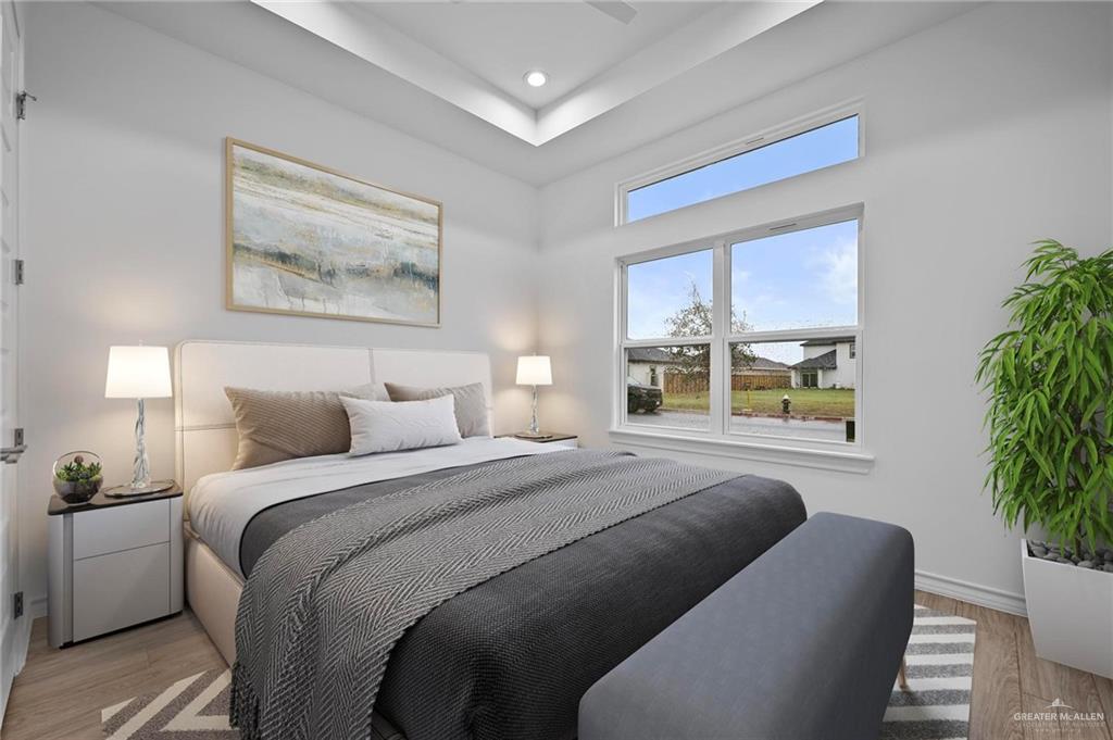 2716 East Conroe Road Edinburg, TX 78542 - Photo 17 of 31 a bedroom with bed and a potted plant