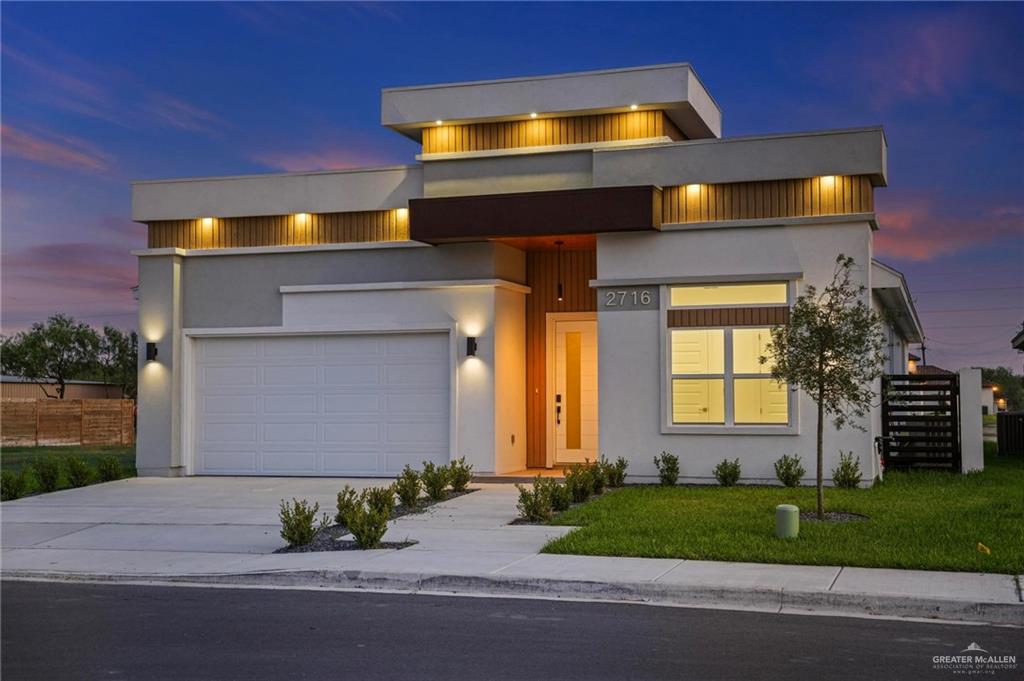 2716 East Conroe Road Edinburg, TX 78542 - Photo 3 of 31 a front view of a house with a yard and garage