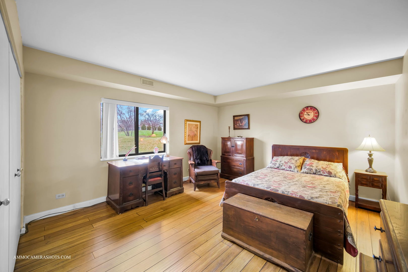 1105 North Mill Street, Unit 117 Naperville, IL 60563 - Photo 12 of 23 a bedroom with a bed and wooden floor