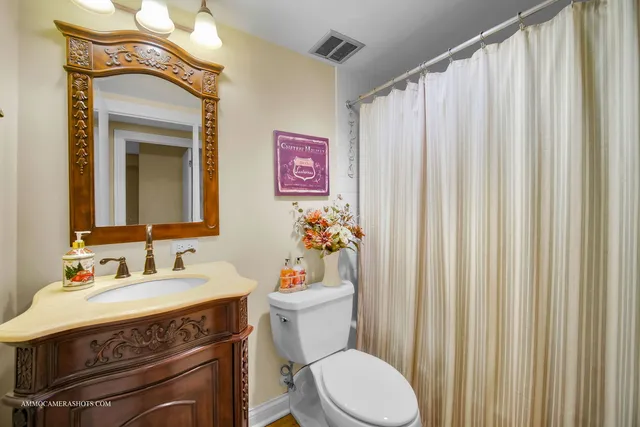 a bathroom with a sink a toilet and a mirror