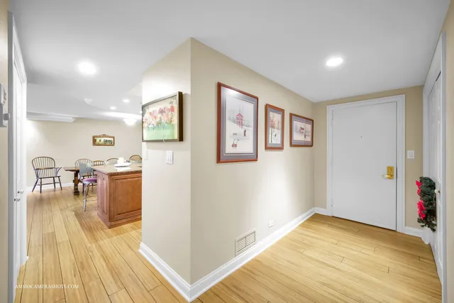 a view of a living room with furniture and wooden floor