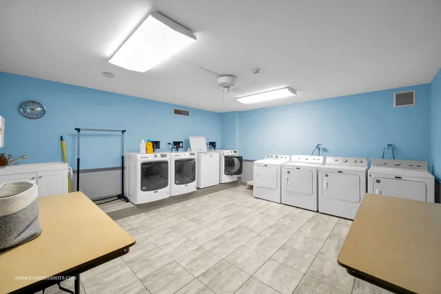a utility room with cabinets and washer dryer