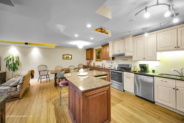 a kitchen with a sink a counter space appliances and cabinets