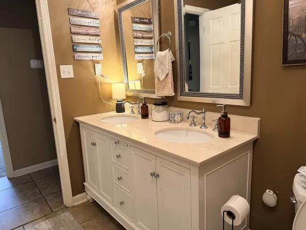 a bathroom with a sink vanity and a mirror