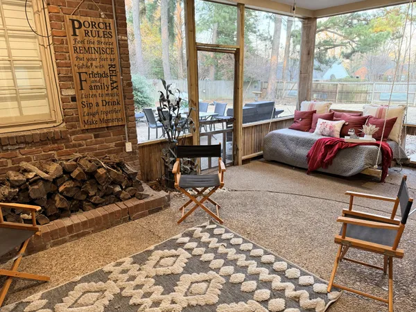 a living room with furniture and a floor to ceiling window