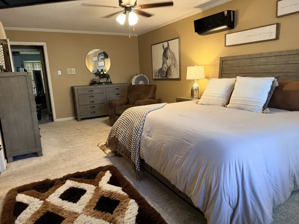 a bedroom with a bed and a chandelier