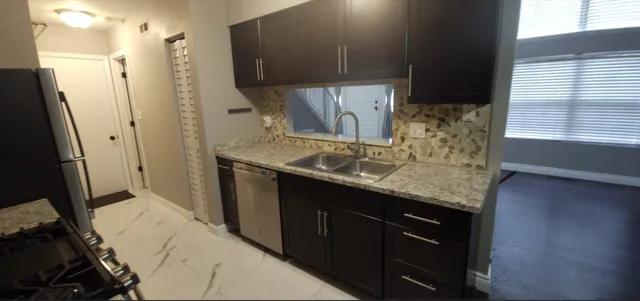 a kitchen with a sink and a refrigerator
