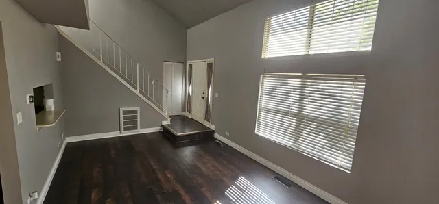 a view of staircase with wooden floor and a window