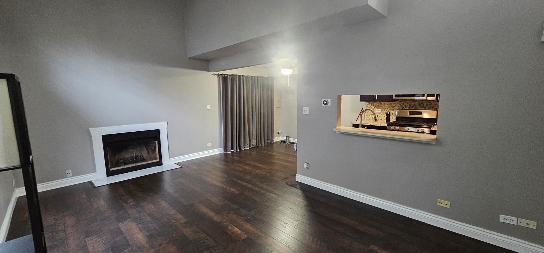 309 Teak Lane Streamwood, IL 60107 - Photo 8 of 16 an empty room with wooden floor fireplace and windows