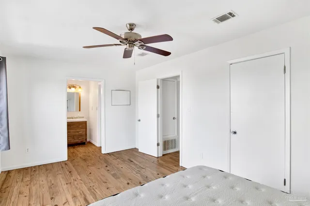a view of a livingroom with wooden floor and window