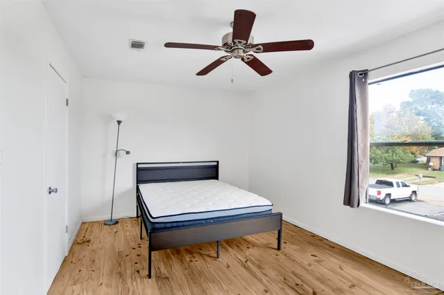 a view of room with a window and wooden floor