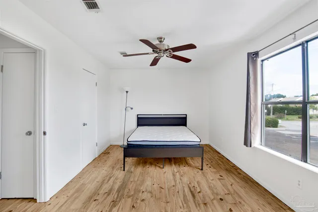 a room with a bed and a window