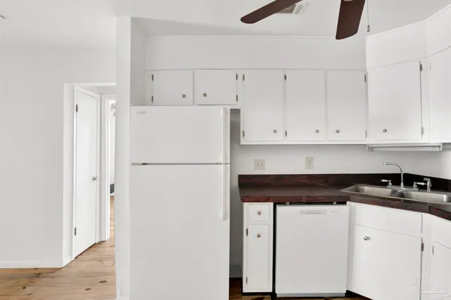 a white refrigerator freezer sitting inside of a kitchen