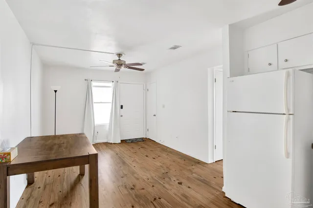 a view of a refrigerator in kitchen and wooden floor