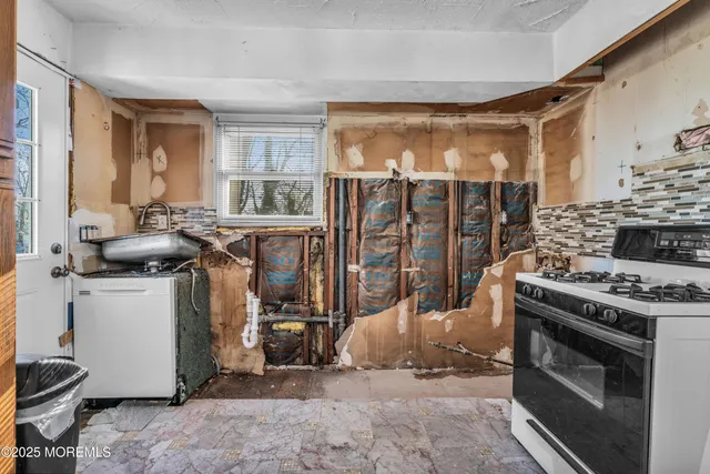 a view of a kitchen with a stove top oven a sink dishwasher and a refrigerator