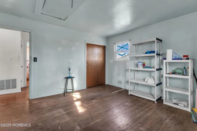 a view of empty room with cabinet and racks