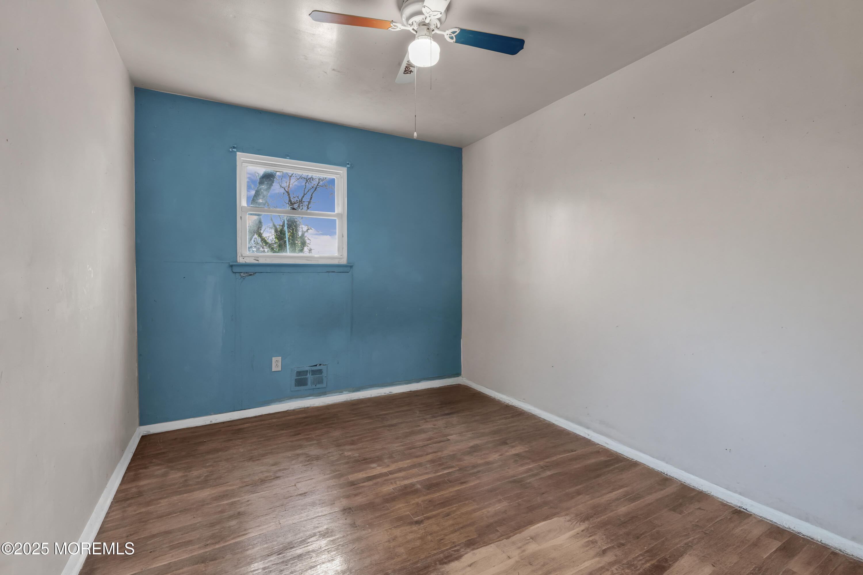 975 South Concourse Keyport, NJ 07735 - Photo 34 of 46 an empty room with a ceiling fan and wooden floor