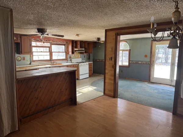 a kitchen with granite countertop a stove and cabinets