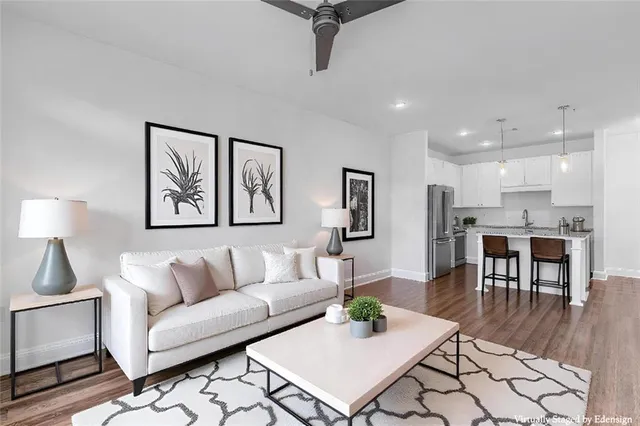 a living room with furniture and kitchen view