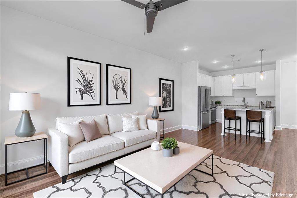 a living room with furniture and kitchen view