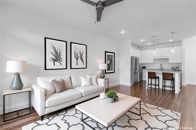 a living room with furniture and kitchen view