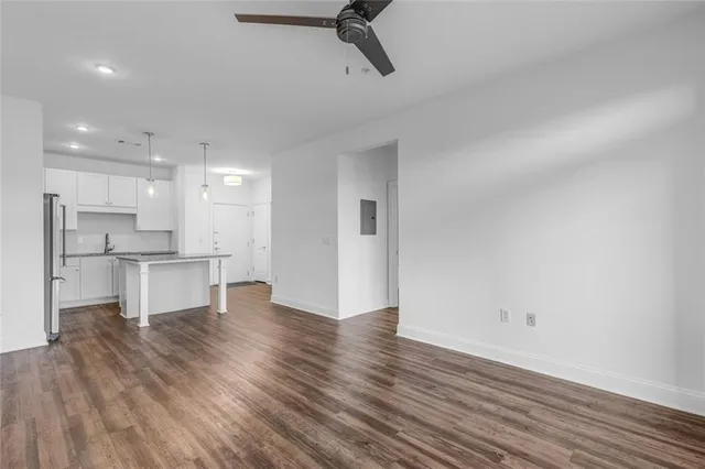a view of kitchen view wooden floor and stainless steel appliances