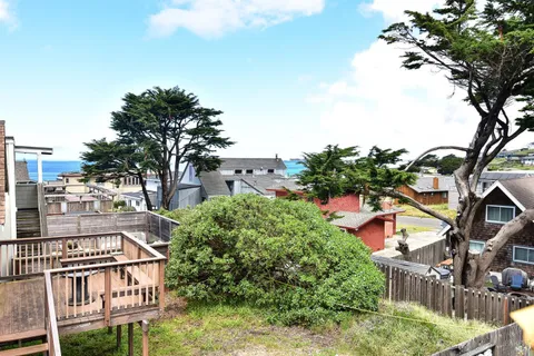 an aerial view of residential houses and car parked