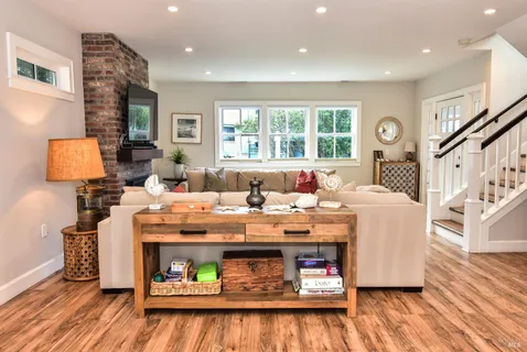 a living room with furniture and a fireplace