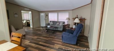403 Hamer Mill Road Rockingham, NC 28379 - Photo 9 of 31 a living room with furniture and a wooden floor