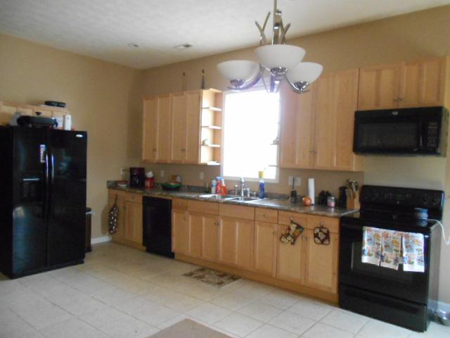 1422 Springplace Road Lewisburg, TN 37091 - Photo 19 of 19 Guest House: This spacious, airy kitchen opens up next to the living room, creating a great open floor plan. Features beautiful cabinets, shelves for growing your spices next to the window, tile floors, and tons of cabinets and counter space!
