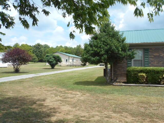 1422 Springplace Road Lewisburg, TN 37091 - Photo 5 of 19 Guest house, seen on the left behind the main home, is on the same tax plat but has a separate mailing address and mailbox.