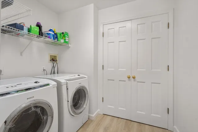 a view of storage and utility room with washer and dryer