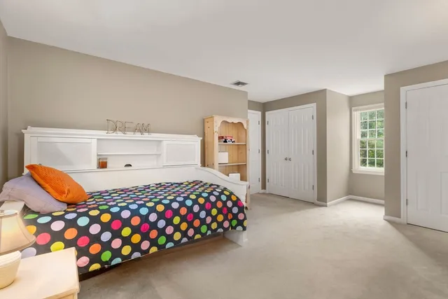 a bedroom with a bed closet and window