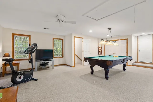 a room with furniture pool table and windows