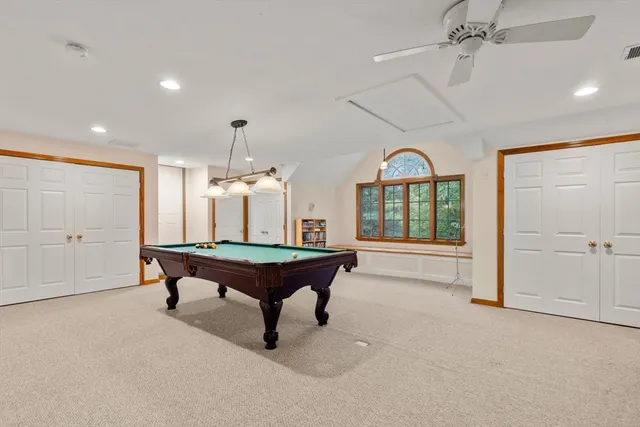 a room with pool table and windows