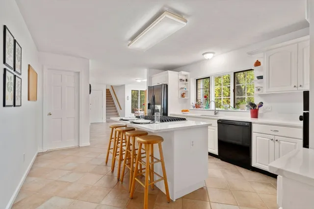 a kitchen that has a lot of cabinets in it and appliances