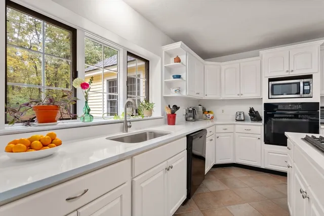 a kitchen with stainless steel appliances granite countertop a sink and cabinets