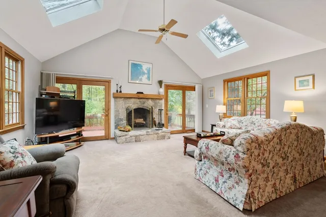 a living room with furniture a flat screen tv and a fireplace