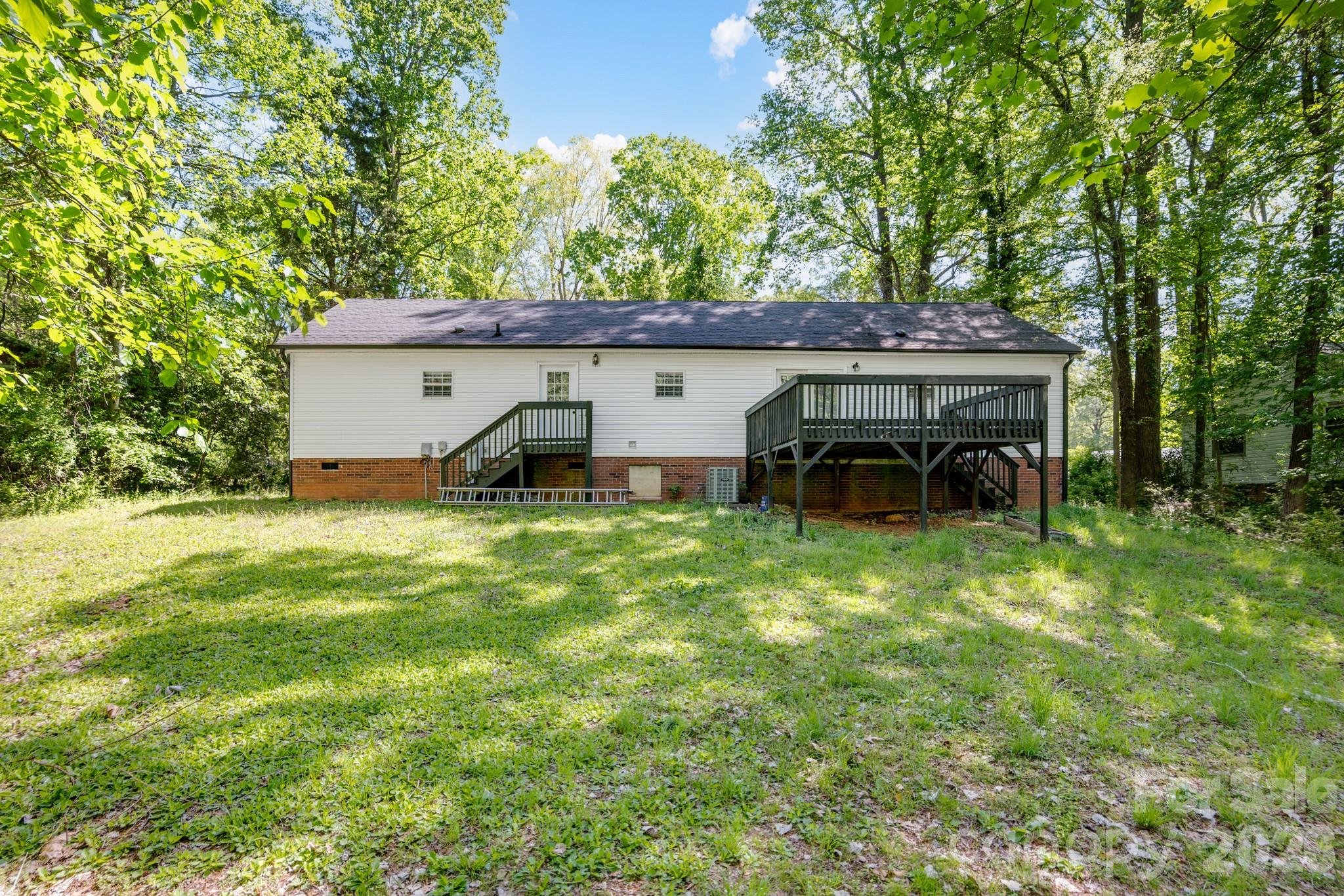 116 Springdale Drive York, SC 29745 - Photo 28 of 32 a backyard of a house with table and chairs