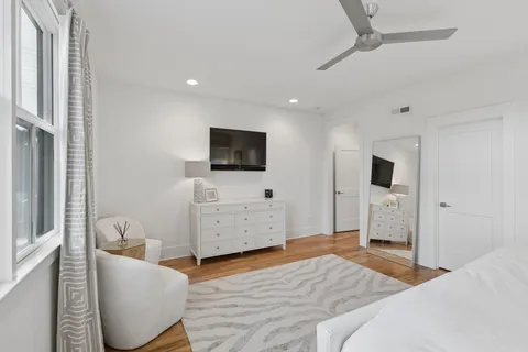 a bedroom with furniture and a flat screen tv