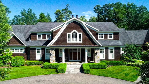a front view of a house with garden