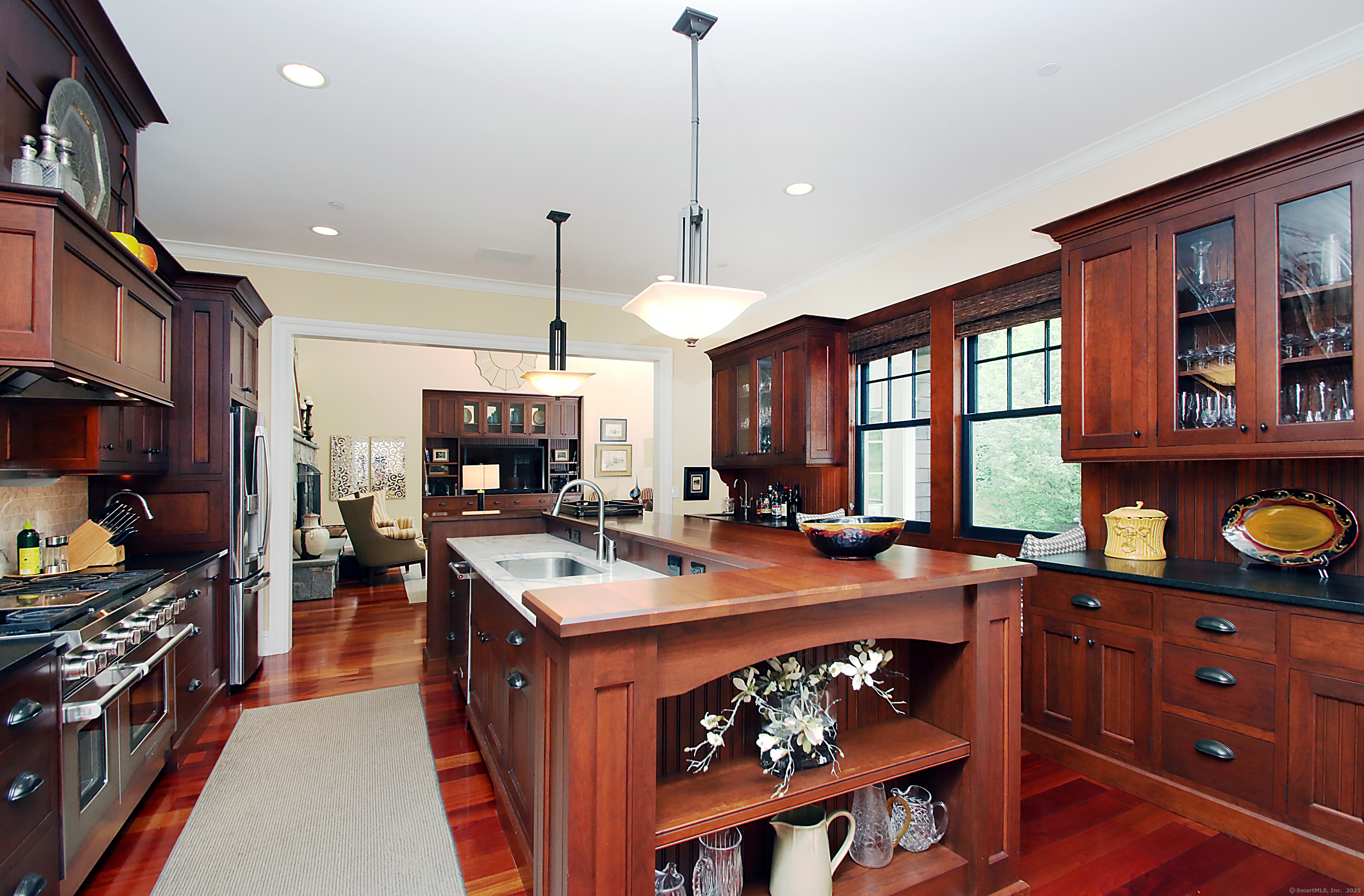 25 Sky View Drive Avon, CT 06001 - Photo 12 of 40 a kitchen with stainless steel appliances granite countertop a stove a sink dishwasher and a dining table with the living room view