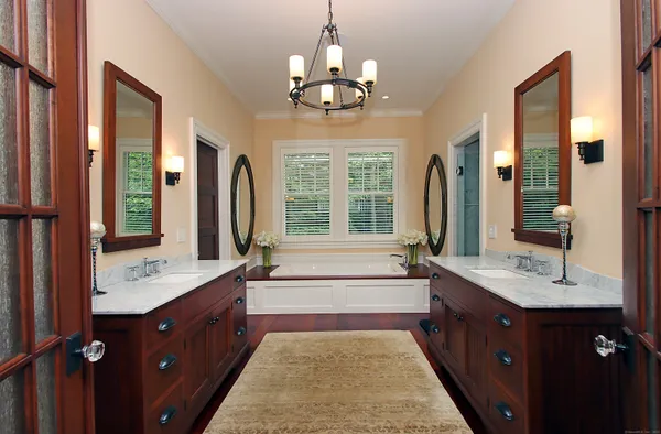a bathroom with a sink a mirror and a window