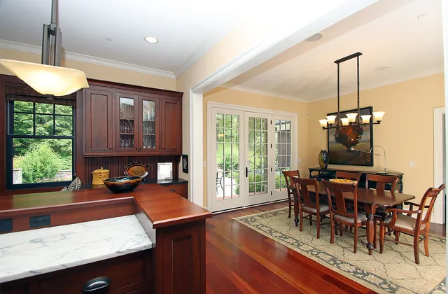 a dining room with furniture and wooden floor