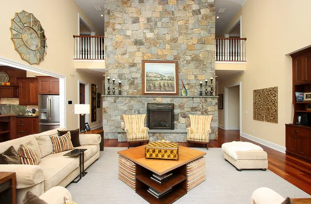 a living room with furniture a flat screen tv and a fireplace