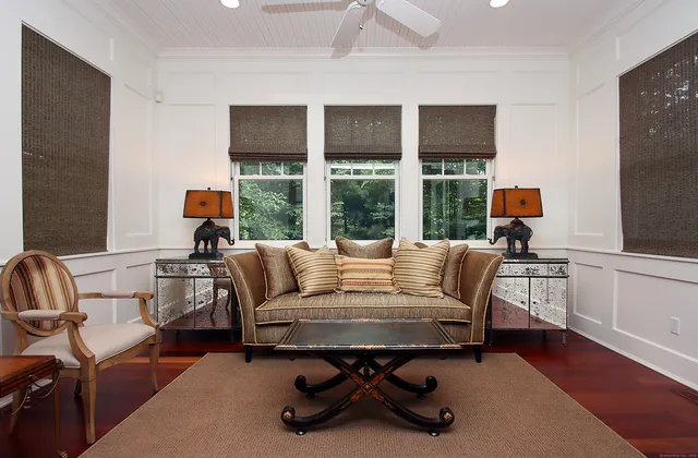 a view of a livingroom with workspace and a window