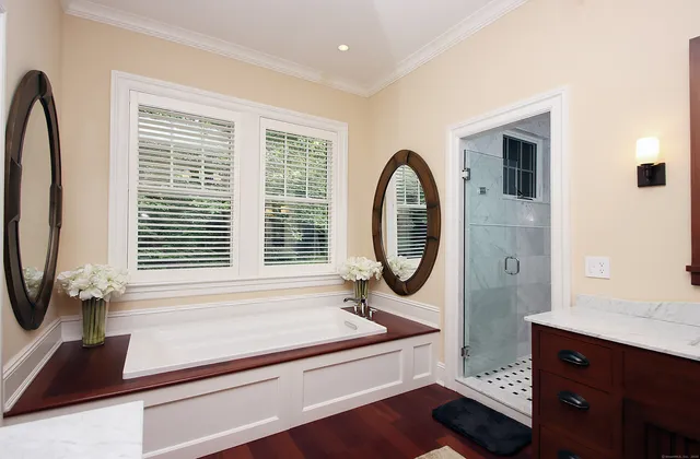 a bathroom with a sink a mirror and a window